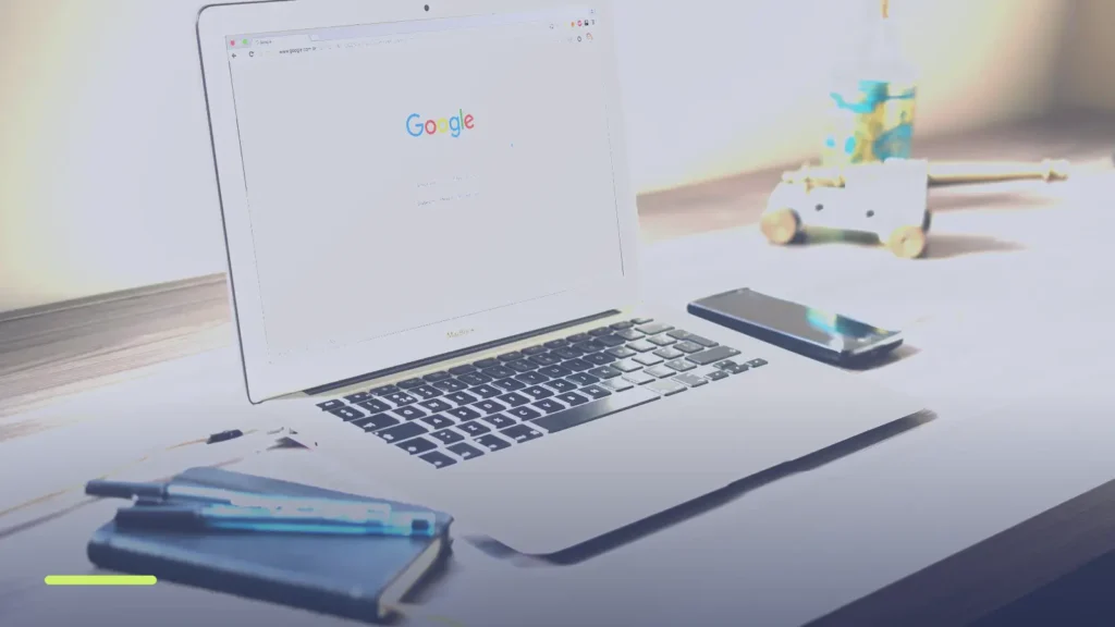 Laptop on a desk showing a Google search page, used to check whether ads are running
