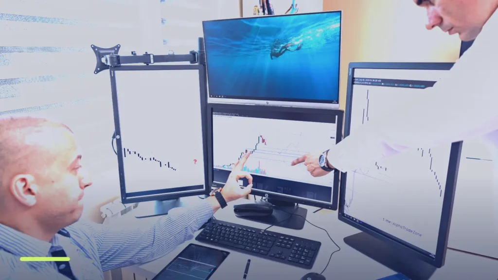 Two analysts comparing charts on multiple monitors while researching competitor Google Ads