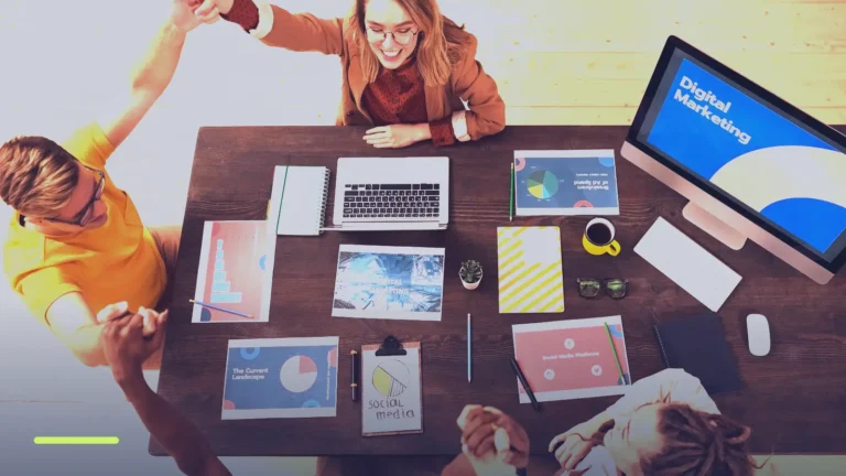 Marketing team around a table with laptops and a screen reading Digital Marketing, planning Google Ads improvements