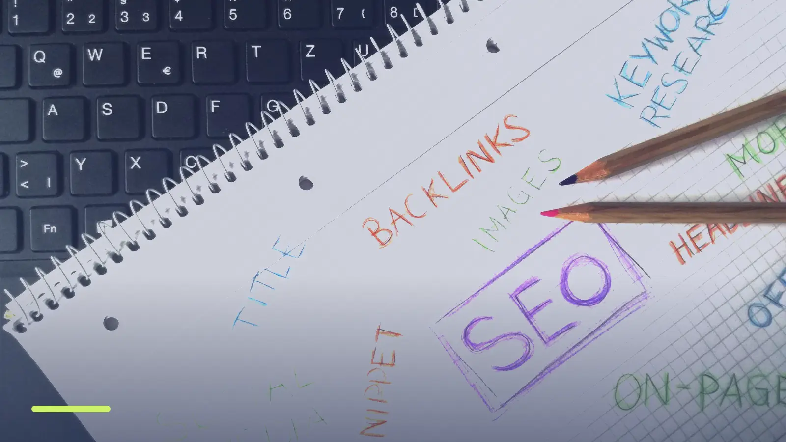 Notebook with handwritten keyword research and SEO notes beside a keyboard