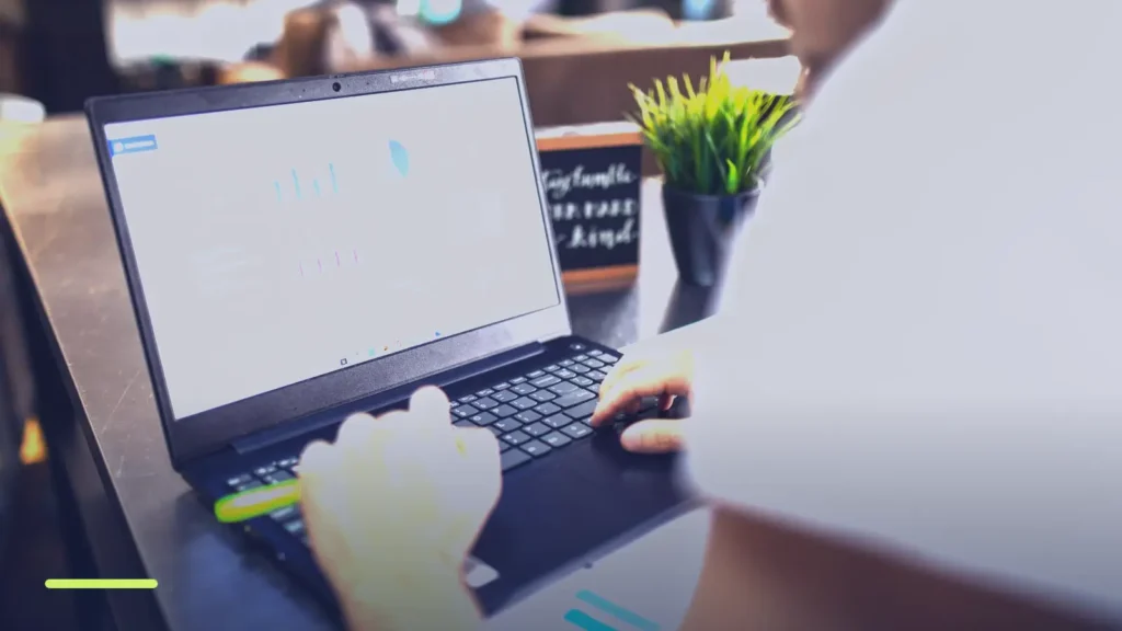 Marketer reviewing campaign charts on a laptop, checking Google Ads Quality Score