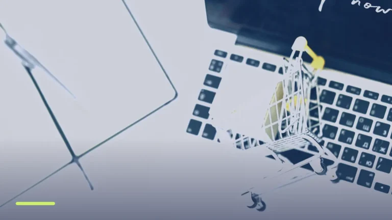 Miniature shopping cart on a laptop keyboard, representing Google Shopping product listing ads